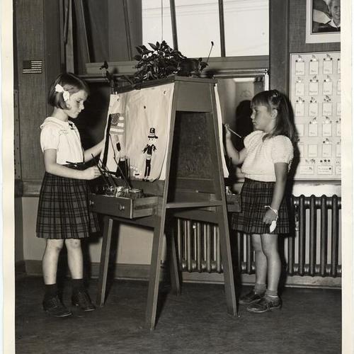 [Two students painting pictures at Francis Scott Key Elementary School]