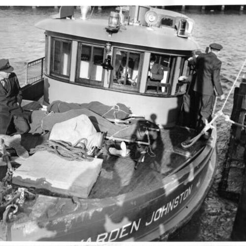 [Alcatraz Prison boat Warden Johnston arriving at Fort Mason with the bodies of three prisoners killed during the three day riot in May, 1946]