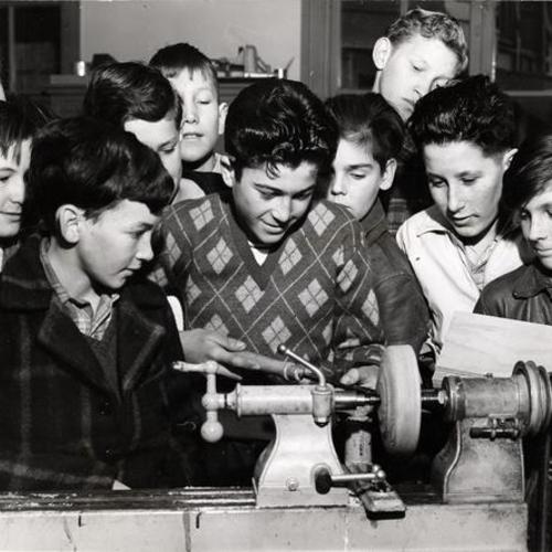 [Boys from the Mission Branch watching a demonstration of a lathe during the National Boys Club Week]
