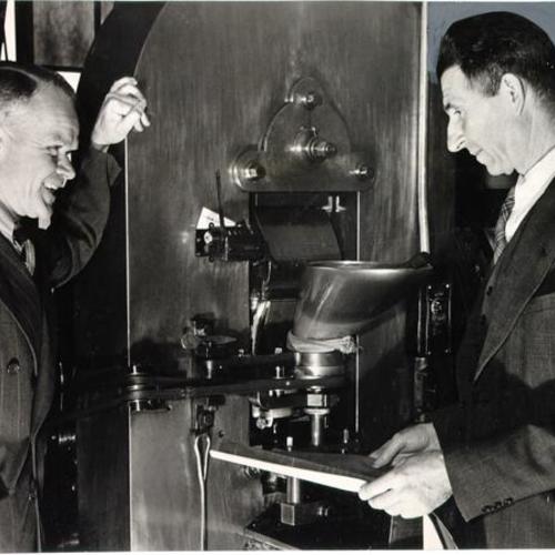 [Employees Joseph W. Steel and W. P. Kruse with a machine of their invention at the U. S. Mint in San Francisco]