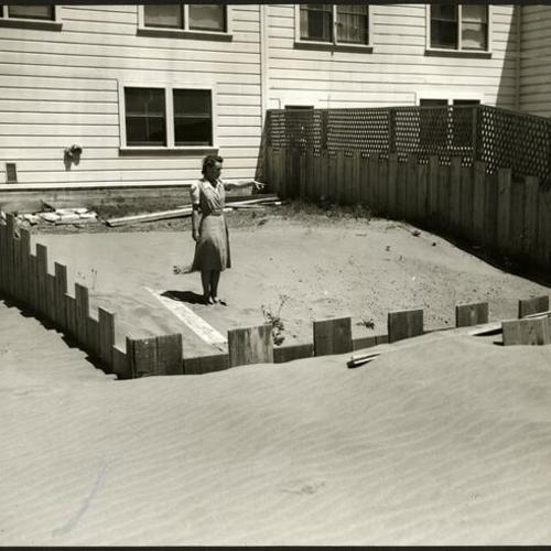 [Mrs. R. L. Anderson standing in the backyard of her Sunset District home]