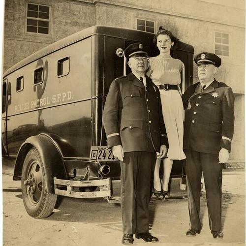 [Police Captain John O'Meara (left) with Ruth Peterson and Lt. Emmett C. Flynn]