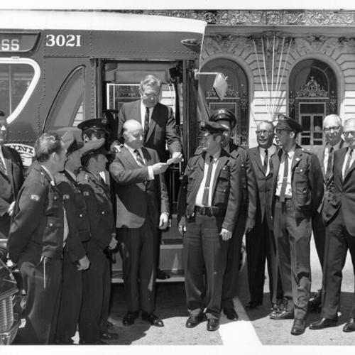 [Mayor Joseph Alioto and others at a dedication of new Muni buses]