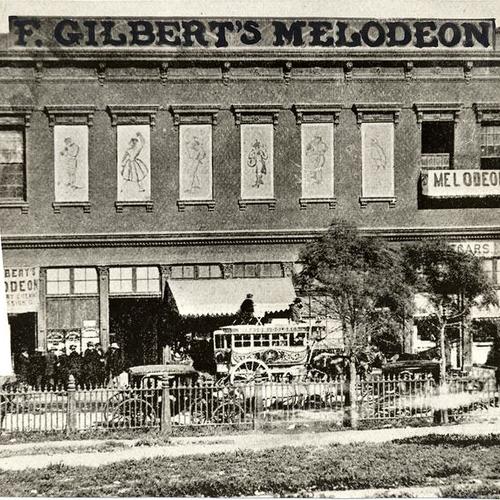  stagecoach and several unidentified people outside of the F. Gilbert's Melodeon theater located at Clay and Kearny Streets]