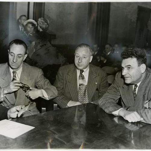 [Harry Bridges with Henry Schmidt and J. R. Robertson, co-defendants in the Perjury-Conspiracy Trial pictured in Federal courtroom]