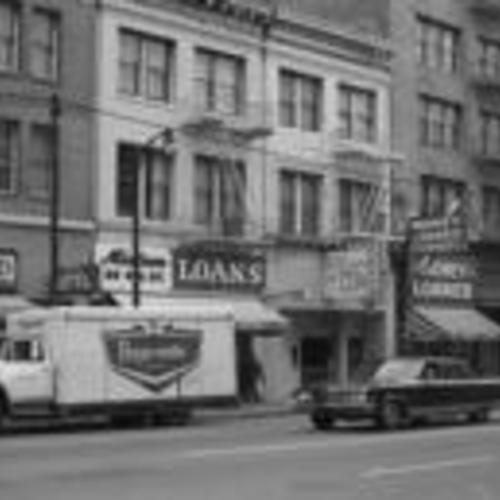 [Store fronts on the first block of 6th Street, including Midtown Loans, Whitaker Hotel, Clover Club, 