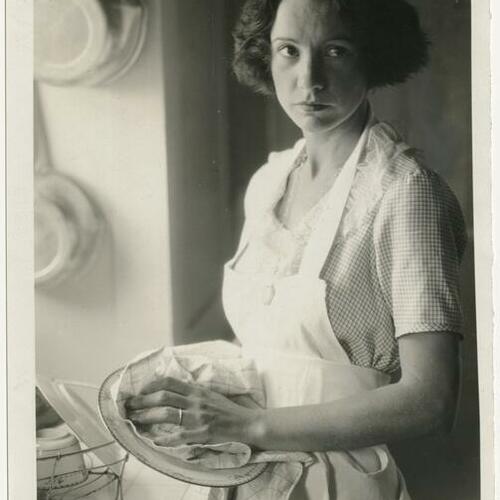 Natalie Talmadge in kitchen washing dishes