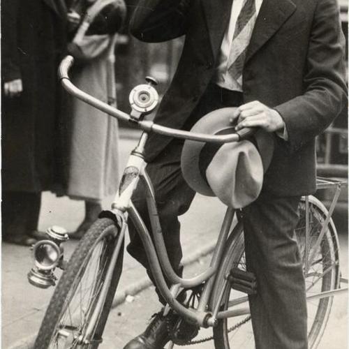 [Clifford Randall riding to work on a bike during general strike]