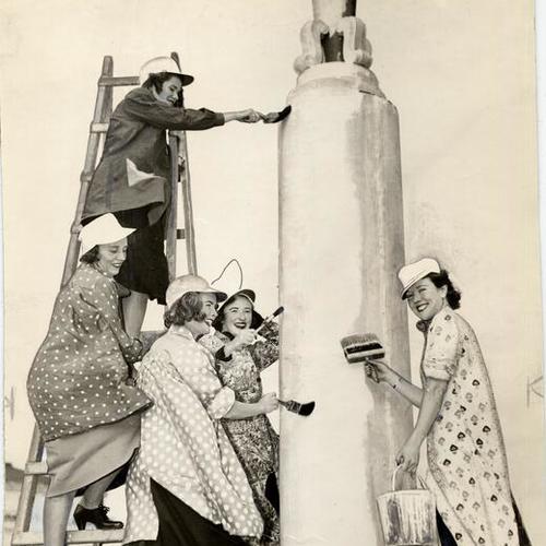 [Miss Constance Avenali, Mrs. R. Lloyd Thomas, Mrs. Clarence Young, Miss Dorothy Anne Doyle and Mrs. Covington Janin painting the standard of the Community Chest torch]