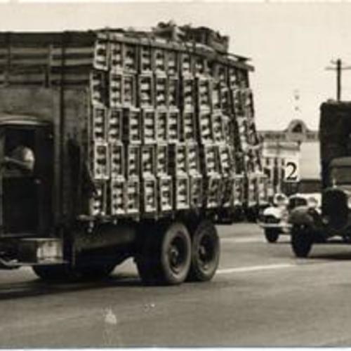 [Police escorting food trucks on the Bayshore Highway during the general strike of 1934]