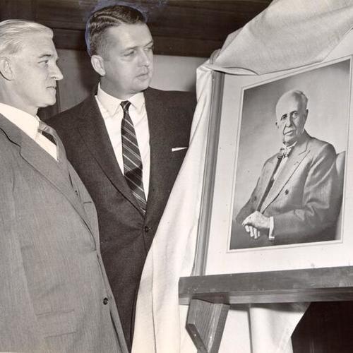 [Harold G. Smith and Kimball Penney looking at an oil painting of J. C. Penney, founder of the chain of department stores in his name]