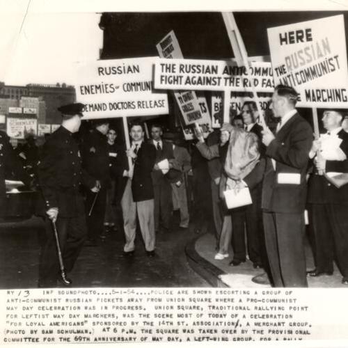 [Police escorting a group of anti-communist Russian pickets away from Union Square where a pro-communist May Day celebration was in progress]