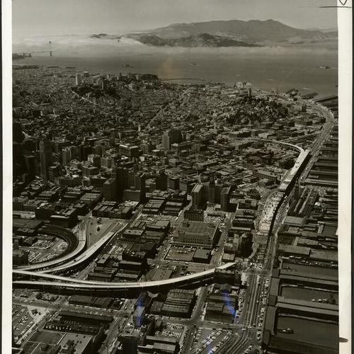 [Aerial view of Embarcadero Freeway with Golden Gate Bridge in the background]