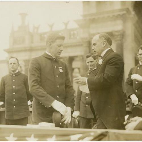 [Mayor James Rolph presenting a medal to a Fire Chief at the Panama-Pacific International Exposition]