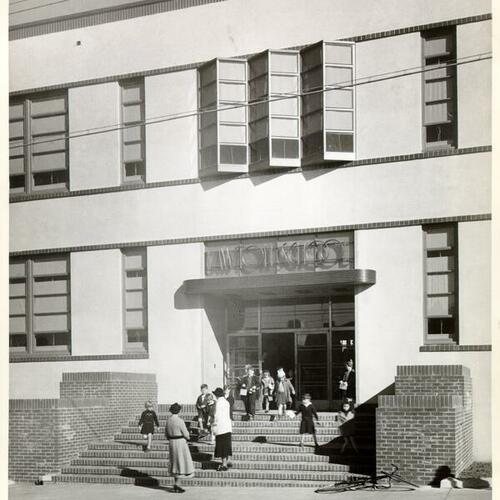 [Children and adults at the entrance to Lawton School]