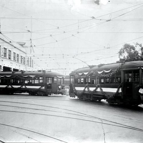 [Geary and Masonic avenue looking east at Geary car house and Muni "A" Type cars used in Special carrying 363d Infantry and 347th Artillery from City Hall to Presidio, April 22, 1919]