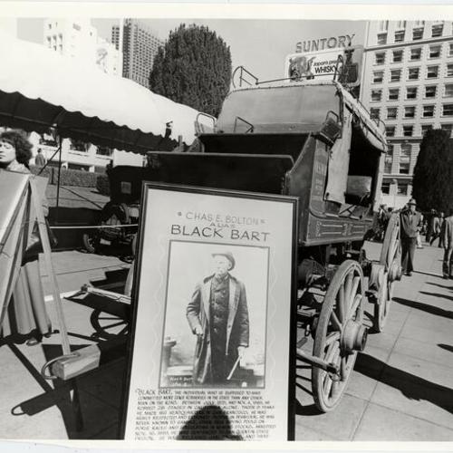 [Poster of "Black Bart" and old stagecoach on display in Union Square]