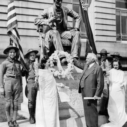 [Supervisor James B. McSheehy placing wreath on Lincoln statue during National Defense Week]