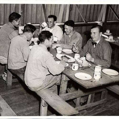 [John Ripley, Henry Jackson and William Minor enjoy army food as part of President Roosevelt's Forest Conservation Corps]