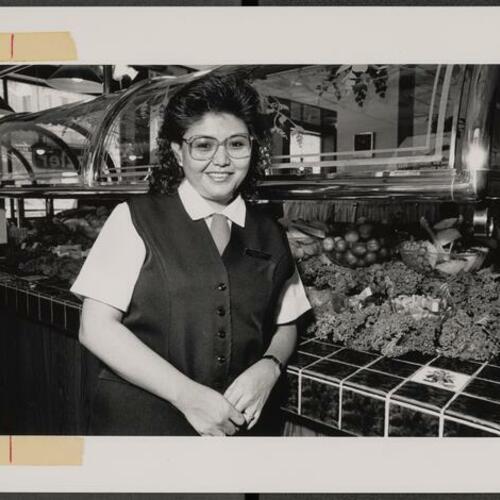 Manager of Tenderloin Sizzler Phoebe Morgan in front of salad bar