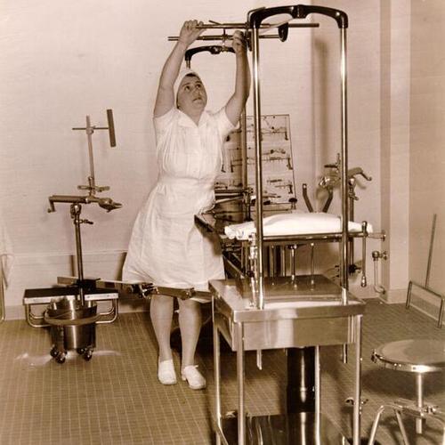 [Hahnemann Hospital nurses Betty Rogers examines orthopedic table]