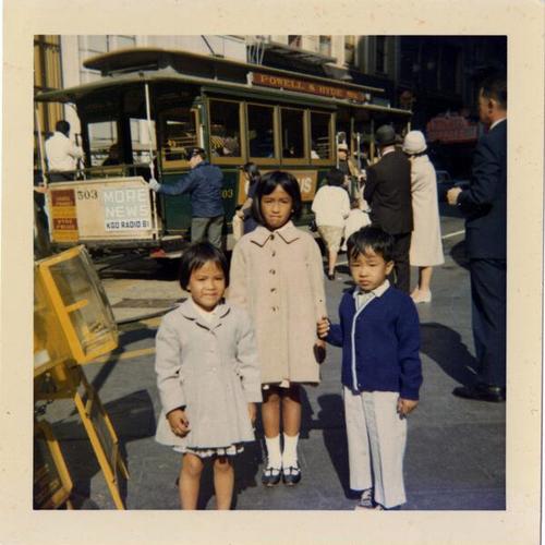 [Grace with her sister Joan and brother Robert on a Sunday stroll on Powell and Market Streets]