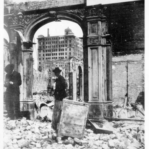 [Two unidentified men standing in the wreckage of the Continental Building after the 1906 earthquake and fire]