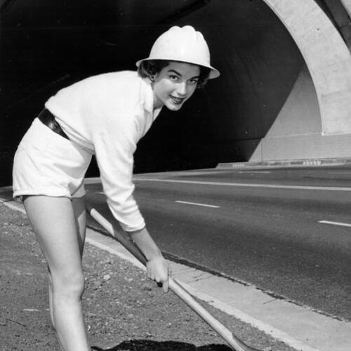 [Eileen Rasmussen shoveling on the side of Waldo Tunnel highway in preparation for opening ceremonies]