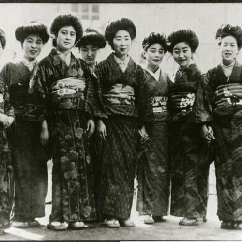 [Eight women dressed up in kimonos]