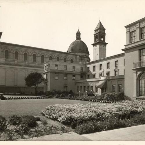 [Faculty houses and lawn at St. Ignatius College with view of St. Ignatius church at rear]