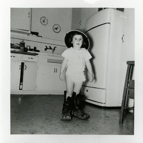 [Connie's sister wearing her father's helmet and boots from Marine Corp from WWII]