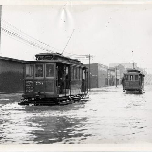 [Streetcars driving through water on Sixteenth Street, at Folsom]