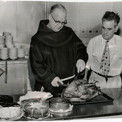 [Father Alfred Boeddeker begins carving one of the turkeys for the Thanksgiving dinners to be served at St. Anthony's Dining Room to San Francisco's less fortunate]