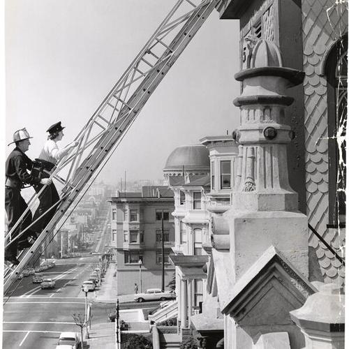 [Park Service Architect Fifi Branner on ladder with Fireman Ray Hines at Fire Engine 15]