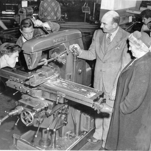 [Bob Woodworth and Ralph Eichenbaum demonstrating "victory work" on a milling machine at Abraham Lincoln High School]