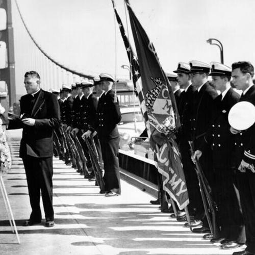 [Matthew F. Connolly delivering memorial prayer  at a ceremony on the center span of Golden Gate Bridge]