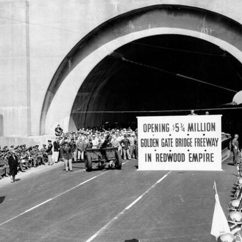 [Crowd of people at the dedication ceremony for Opening of Waldo Tunnel with presence of tank, cannon, and military officials]