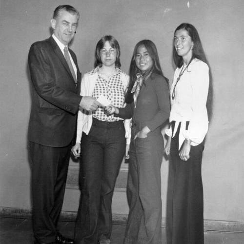 [Principal James Kearney congratulating winners of a public speaking competition at Lowell High School]