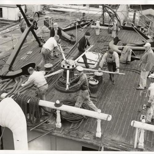 [Men working on deck of the sailing ship "Balclutha"]