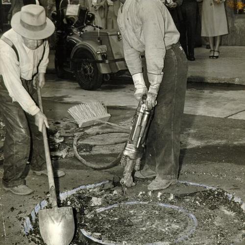 [Workmen digging up a manhole at 4th and Market]