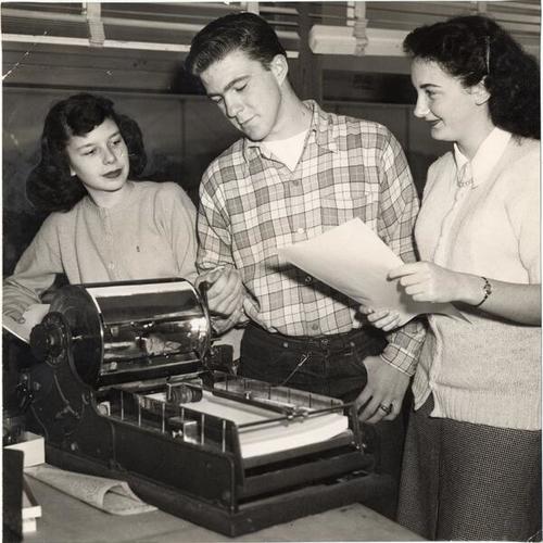[Journalism students Doras Childers, Jim Schonbeck ad Diane Armos running off mimeographed information for other students desiring to write a letter to the United Nations Organization General Assembly]