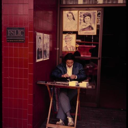Chinatown portrait artist stand in doorway