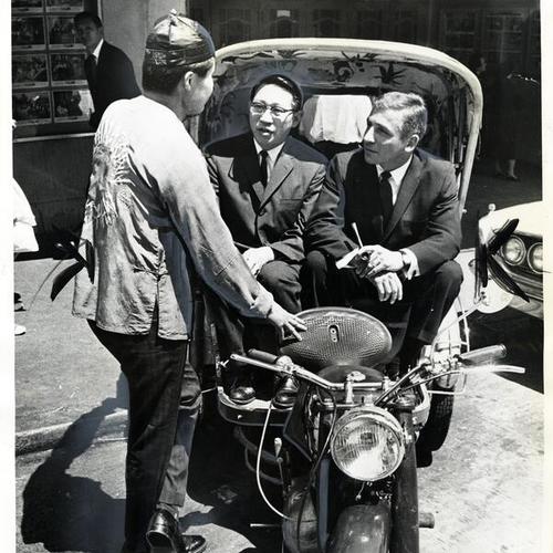 [Rickshaw operator, Ed Jung, giving Dr. Thomas Wu and Jay Jackson a preview of his services]