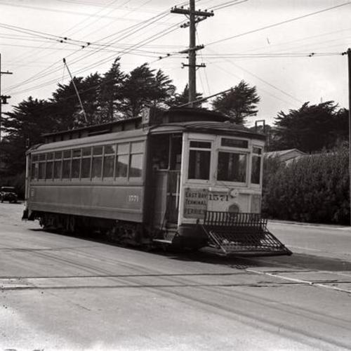 [Ocean avenue and Tara street looking west at inbound #12 car 1571 crossing Southern Pacific "old main line" tracks]