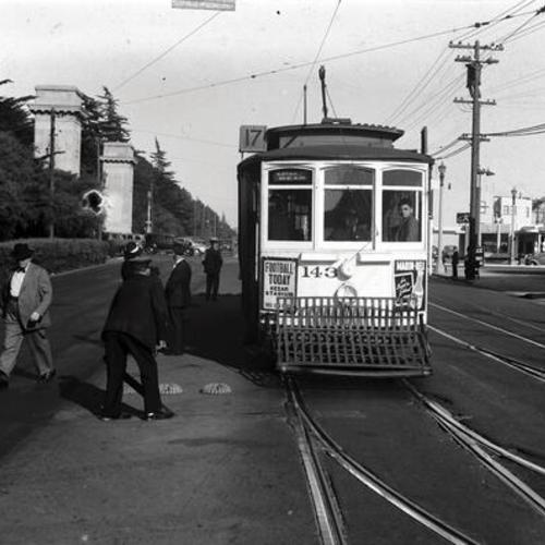 [Lincoln Way and 20th avenue looking east at conductor lifting switch lever in front of outbound #17 line car 143]