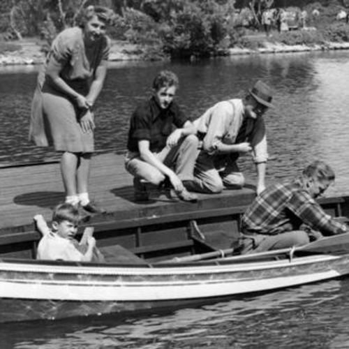  family preparing to take a ride in a rowboat on Stow Lake in Golden Gate Park]