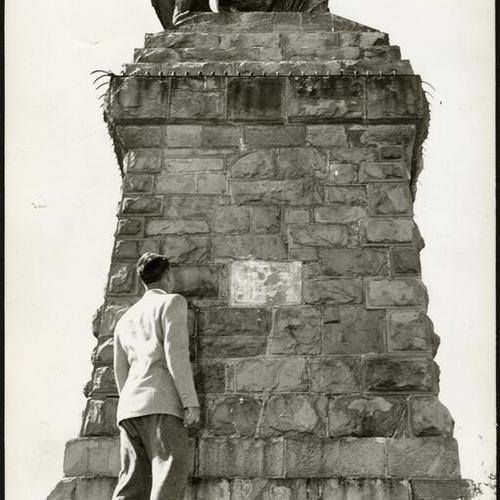 [Man standing in front of the "Triumph of Light" monument on Mt. Olympus in San Francisco]