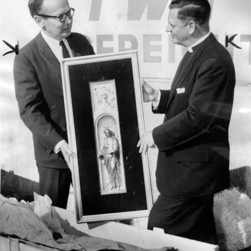 [Earl Anderson and Very Rev. C. Julian Bartlett, dean of Grace Cathedral, examining one of five panels]