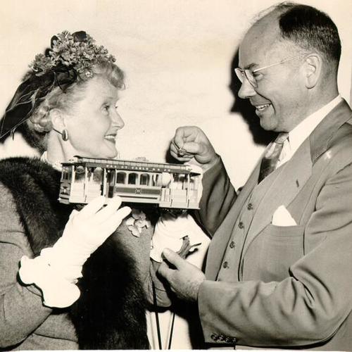 [Chris J. Christensen presenting actress Billie Burke with a cable car pin]