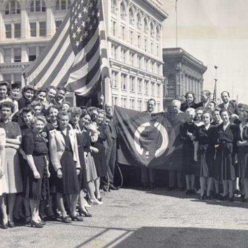 [Employees of I. Magnin being awarded a "bulls-eye flag" for pledging 10 percent of their wages to purchase of war bonds]